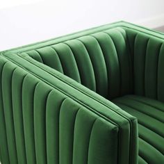 a green couch sitting on top of a white floor