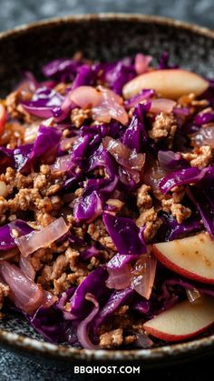 a close up of a bowl of food with meat and vegetables in it on a table