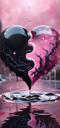 a heart shaped object floating on top of a body of water with dripping liquid coming out of it