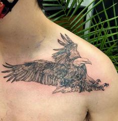 a man with a tattoo on his chest has an eagle in the middle of it