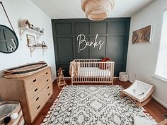 a baby's room with a crib, dresser and rug in the corner