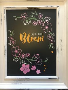 a chalkboard with the words live life in full bloom painted on it