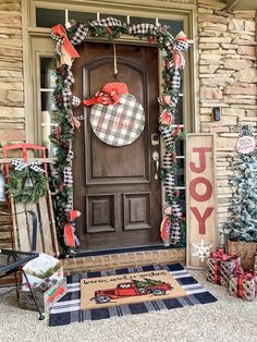 a front door decorated for christmas with holiday decorations