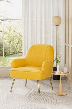 a yellow chair sitting in front of a window next to a table with a potted plant