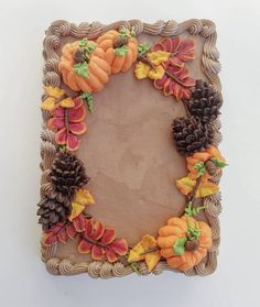 a cake decorated with fall leaves and pumpkins