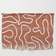 a piece of art with white lines on an orange wall hanging from it's side