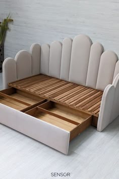 a white couch with two drawers underneath it