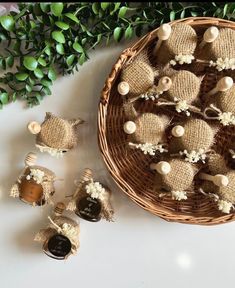 a basket filled with lots of little stuffed animals sitting next to each other on top of a table