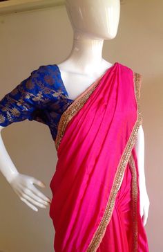 "Gorgeous glowing pink semi silk saree with a beautiful stone work border and silk unstitched blouse in blue silk brocade. The blue brocade is simply stunning when paired with the hot pink saree. Saree length 5.5 meters Blouse fabric 1 meter 44\" wide Saree ships in 2-3 days of payment.Shipping time is 4-5 days with tracking. We also offer blouse and petticoat stitching for saree as additional services. Please convo me if you need help or have any questions." Hot Pink Saree, Pink Saree Blouse, Gold Sequin Blouse, Hot Pink Blouses, Brocade Blouse, Anarkali Dress Pattern, Plain Saree, Brocade Blouses, Sequin Blouse