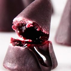 a close up of a piece of food on a fork with blood coming out of it