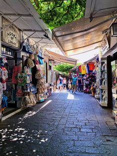 an outdoor market with lots of items on display