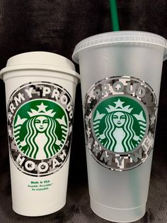 two starbucks cups are shown side by side on a black background, one is white and the other is green