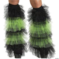 the legs of a woman wearing green and black tulle skirtes with ruffles