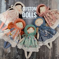 four dolls are sitting in a circle on a wooden surface with the words custom dolls above them