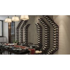 a dining room table with wine racks on the wall