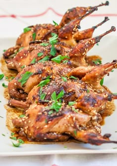 chicken wings on bread with herbs and seasoning sprinkled on top, ready to be served