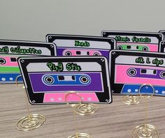 there are four place cards that have cassettes on them