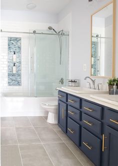 a bathroom with blue cabinets and white walls