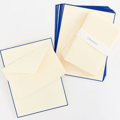 three blank cards with blue envelopes on them