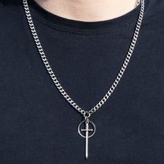 We couldn't resist, here's another sword necklace!  This time featuring a sword pendant centrepiece with an o ring behind it on a small cuban chain with a lobster clasp. This comes in 2 lengths allowing it to sit how you like! The2 lengths (the length of chain only - not including sword and washer) are: 56cm and 66cm.  Great match for our 'knights of cydonia' earrings and layers well with other designs  Quite lightweight Clasp: lobster clasp  Material: 100% Stainless steel  - won't tarnish or st Streetwear Metal Jewelry With Curb Chain, Fashion Metal Curb Chain Jewelry, Cross-shaped Stainless Steel Streetwear Jewelry, Cross-shaped Stainless Steel Jewelry For Streetwear, Stainless Steel Cross Jewelry For Streetwear, Metal Curb Chain Jewelry For Streetwear, Punk Streetwear Cross Necklaces, Punk Cross Necklace For Streetwear, Streetwear Cross Pendant Chain Jewelry