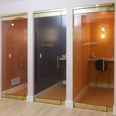 three glass doors in an office with a desk and chair on one side, and another door to the other