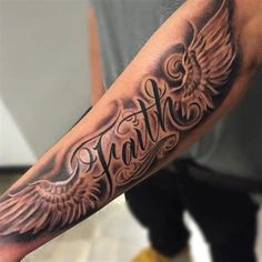 a man with a tattoo on his arm that reads faith and has wings around it