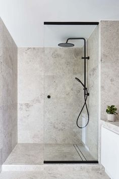 a bathroom with a walk in shower next to a sink