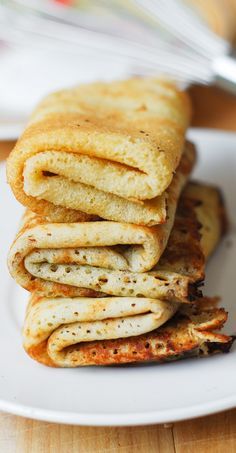 a stack of pancakes sitting on top of a white plate