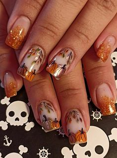 a woman's nails with orange and white designs on them