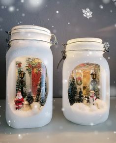 two mason jars decorated with christmas scenes