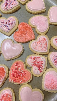 some heart shaped cookies are on a pan