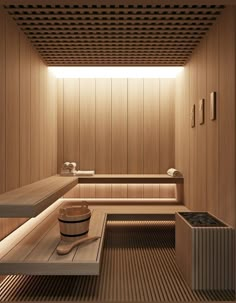 a sauna room with wooden walls and flooring is lit by recessed lighting