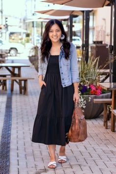 Top 18 Soccer Mom Outfits To Look Stylish In 2023 Black Dress With Jeans Jacket, Western Outfits Women Jean Jacket, Denim Jacket With Black Dress, Denim Frocks For Women, Black Midi Dress Outfit Summer, Jeans With Slides, Black Dress With Jean Jacket, Boho Jackets For Women, White Slides Outfit