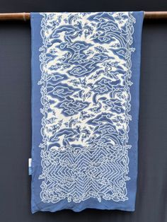 a blue and white scarf hanging on a clothes line