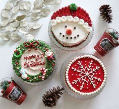 three decorated christmas cakes sitting on top of a table