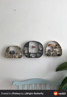 there are three shelves on the wall with jewelry in them