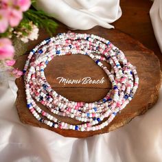 Bring a touch of tropical elegance to your jewelry collection with our "Miami Beach" seed bead bracelet. This extra-long design allows you to wrap it around your wrist 12 times (on an average 7 inch wrist) for a layered look or even wear it as a necklace or anklet for added flair! 👙 *While each bracelet is handmade and may vary slightly, they are crafted to resemble the original design as close as possible. With that in mind, we hope you cherish this one-of-a-kind treasure made just for you! Heishi Beads Multi-strand Bracelets For Beach, Beach Multi-strand Colorful Beaded Bracelets, Colorful Multi-strand Beaded Bracelets For Beach, Multi-strand Colorful Beads Friendship Bracelets For Beach, Beach Wrap Bracelet With Spacer Beads, Beach Wrap Bracelet With Tiny Beads, White Multi-strand Beaded Bracelets For Beach, White Multi-strand Beach Bracelets, Multi-strand Beaded Bracelets For Beach