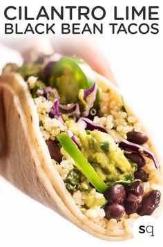 a close up of a taco with beans and broccoli in it on a white background