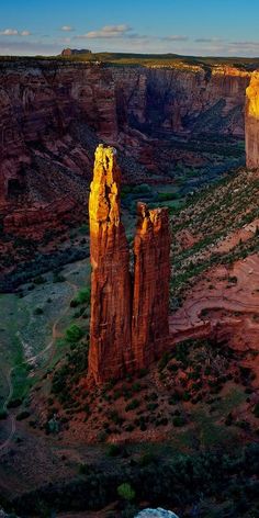 an aerial view of canyons and cliffs in the desert, with sunlight shining on them