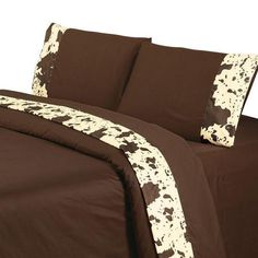 brown and white bedding with cow print on it