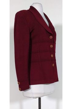 Classic blazer in a rich burgundy color. Embellished gold buttons add a polished look to the garment. Size 8 Knit fabric Made in U.S.A Button down front Padded shoulders Rounded embellished buttons Bust 38" Waist 34" Shoulder to hem 24.25" Semi-formal Burgundy Blazer For Fall, Elegant Burgundy Office Blazer, Formal Burgundy Outerwear With Buttons, Formal Burgundy Blazer For Fall, Formal Fall Blazer With Gold Buttons, Formal Blazer With Gold Buttons For Fall, Elegant Burgundy Blazer For Winter, Elegant Burgundy Outerwear With Button Closure, Fall Wool Blazer With Gold Buttons