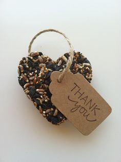 a heart shaped bird feeder with a thank you tag