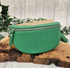 This green Italian leather hip bag is an updated street-ready design of the bum bag, which helps you keep your essentials organized and your hands free. This one design can be worn 3 different ways: around the waist like the traditional bum bag, across body to give it that modern vibe or over-shoulder which again gives it that updated look. Absolutely perfect for holidays and days or nights out. Different colours and different ways to wear the bag can be seen in the photographs. Wear it with the strap which comes with the bag, or team it up with one of our patterned bag straps. This hip bag COMES WITH THE STANDARD slim line LEATHER STRAP in the same colour as the hip bag, as shown in pictures 1 to 6. The additional print patterned bag strap shown in the other photograph is for illustration Trendy Green Belt Bag For Everyday, Green Belt Bag With Zipper Pocket For Everyday Use, Green Crossbody Belt Bag For Everyday Use, Green Belt Bag For Everyday With Mobile Phone Holder, Everyday Green Belt Bag For Mobile Phone, Green Leather Belt Bag For Daily Use, Green Belt Bag With Removable Pouch For Daily Use, Trendy Green Belt Bag With Mobile Phone Pocket, Trendy Green Belt Bag With Mobile Phone Holder