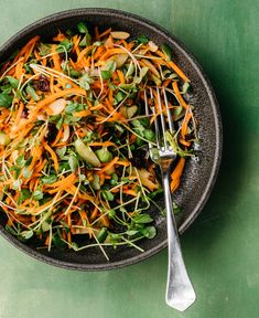 a salad with carrots, lettuce and other vegetables