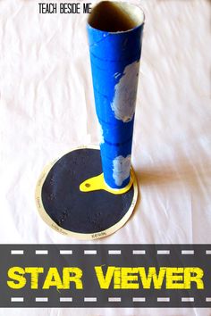 a tall blue vase sitting on top of a white bed next to a black plate