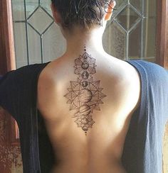 a woman with a tattoo on her back