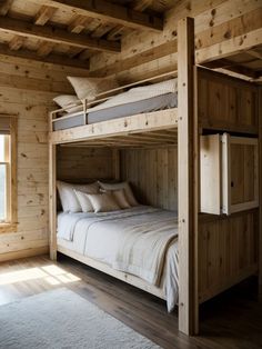 a bunk bed in a room with wooden walls and flooring that is made out of wood planks