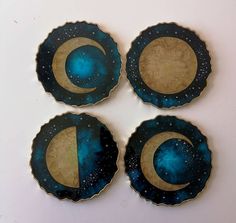 three plates with blue and gold designs are on a white table top, one has a half moon in the middle