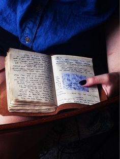 a person holding an open book in their hands