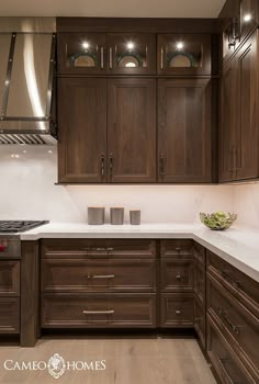 a kitchen with wooden cabinets and white counter tops